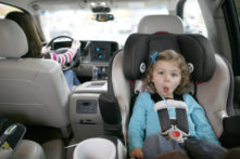 This picture shows a toddler in a rear-facing convertible car seat.