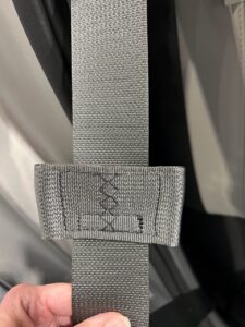 A latchplate stop on a seat belt, this is a bow-tie-style.
